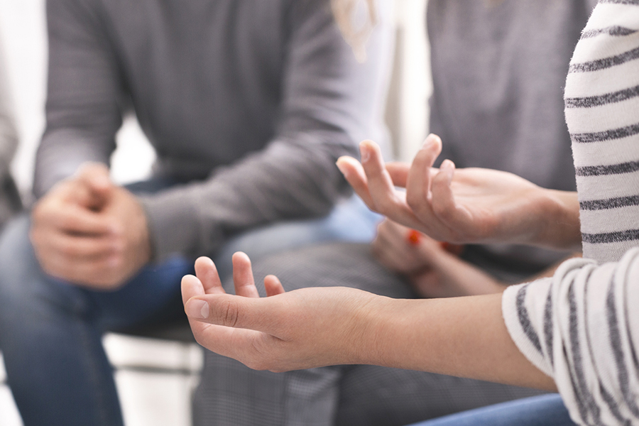 A close up of someone's hands being expressive in a meeting