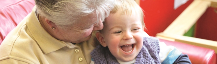 A laughing child with her grandmother