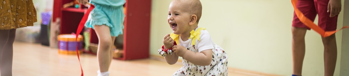 A toddler playing in a group