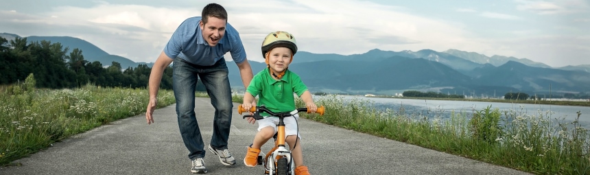 A child learning to ride a bike