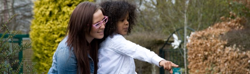 An adult and child in a garden