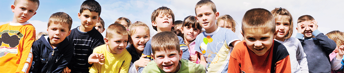 Smiling children all looking at the camera