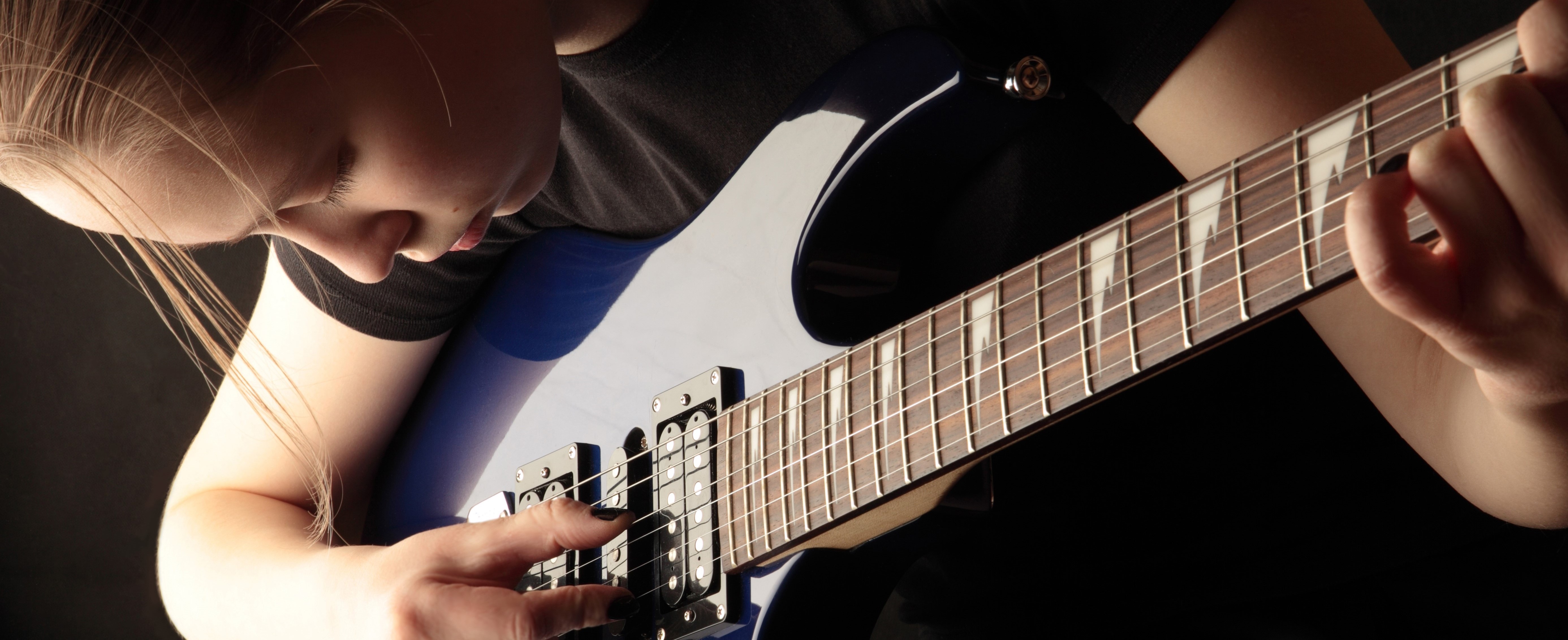 A close up of someone playing the guitar