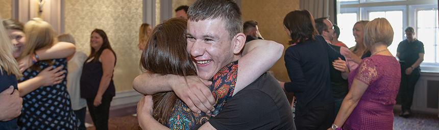 Two teenage friends hugging