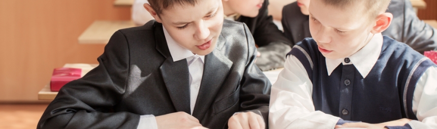 Two children reading a book in school