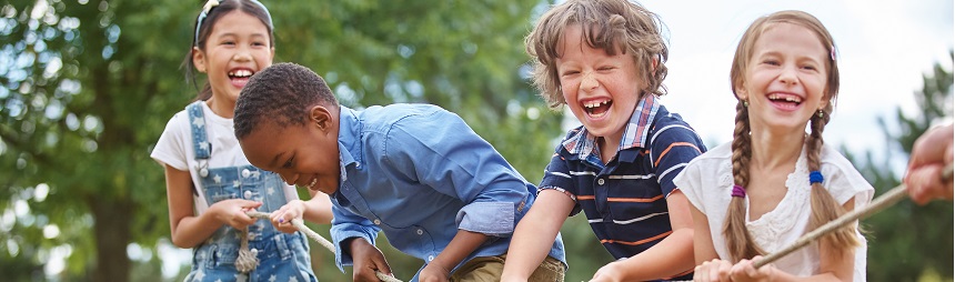 Laughing children pulling a rope