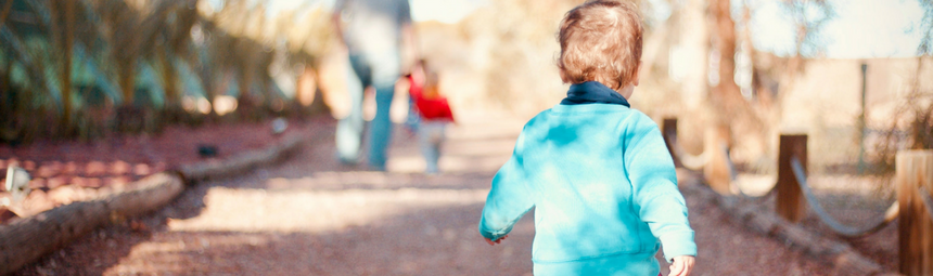 A child outside running away from the camera