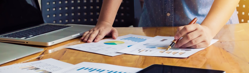 Someone looking at spreadsheets on a desk