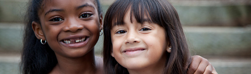 Two young girls smiling at the camera