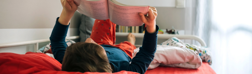 A child reading on her bed