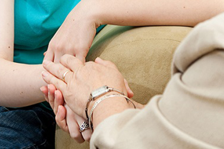 Two people holding hands