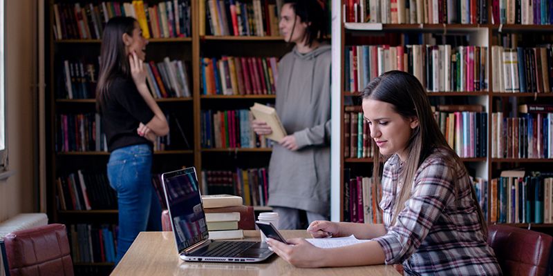 Students working in a college library