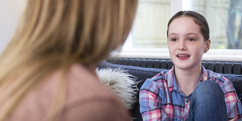 A young person talking to an adult