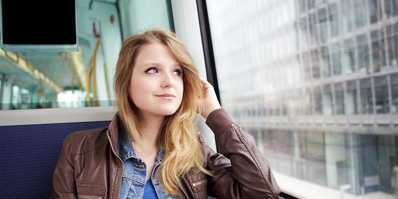 A teenager looking out of a bus window