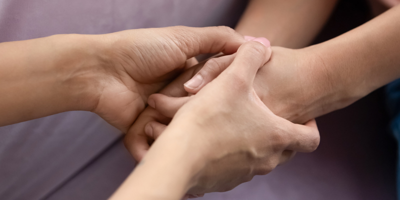 Two pairs of hands, one enveloping the other