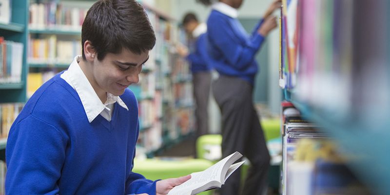 A pupil reading in a school library