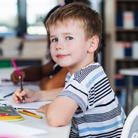 A child at school, smiling to camera