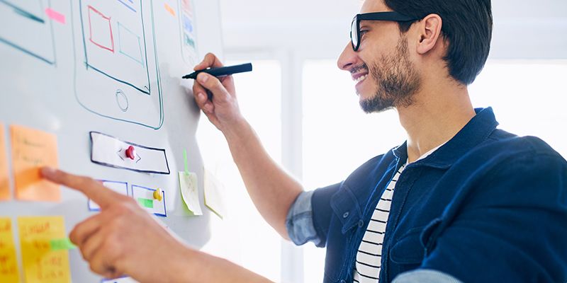 A man writing on a whiteboard