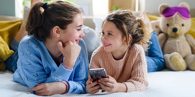 Two girls looking at a mobile phone