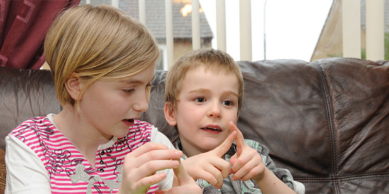 two children counting on their fingers