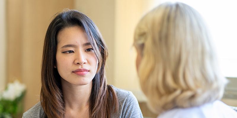 A generic image of a counsellor talking to a young person.