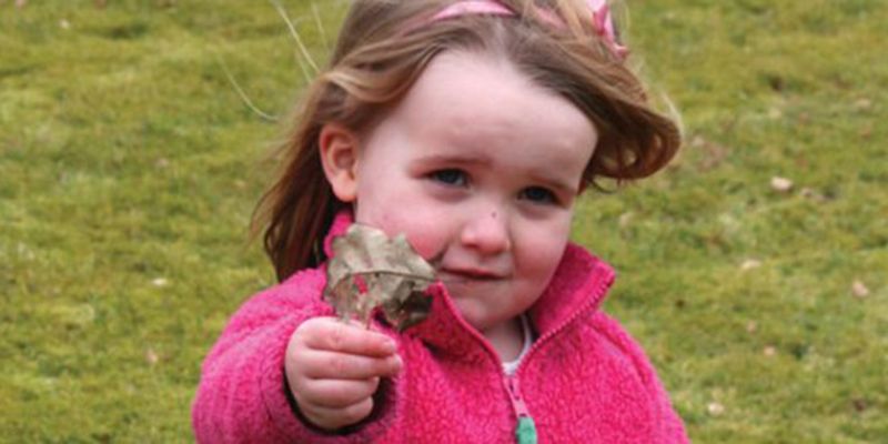 A child holding a leaf