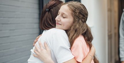 Two teens hugging