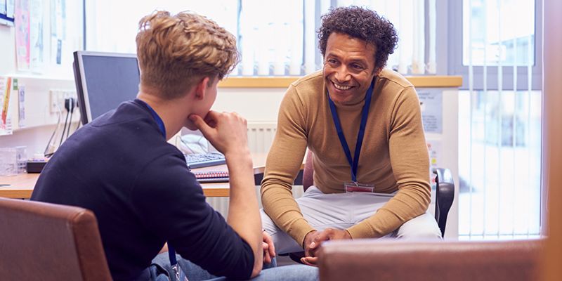 A young person talking to their social worker