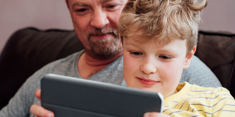 Father and son looking at a tablet