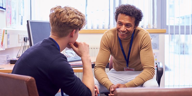 A teenager talking to his social worker